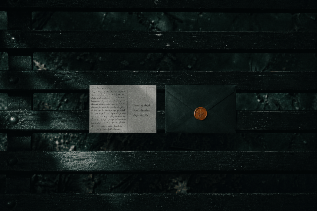 Postcard and sealed envelope on a park bench illustrating AI acceptable use policy confidentiality gap